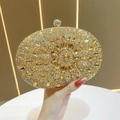 Elegant sunburst crystal evening clutch bag with gold and silver rhinestones in hand - Gold