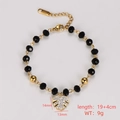 Detail of black faceted bead bracelet featuring a gold leaf pendant with pave crystals - Maple Leaf Pendant Style