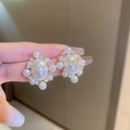 Macro shot of faux pearl earrings with golden trim and sparkling crystal center design - White Circle Pearl Oval (32#)