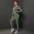 Sage green yoga set detail showing long sleeve crop top with thumbholes and ribbed texture - Medium Grey
