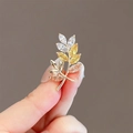 Detail of leaf brooch with gold finish and inlaid white, yellow, and champagne crystals - 133# Rice Flower