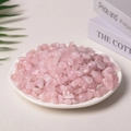 Natural polished rose quartz crystal chips displayed in a white ceramic dish - Rose Quartz Deep Color Enhanced (9-12mm) 100g