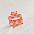 Close-up of a square checkered hair claw clip in orange and white acetate finish - Orange/White 5cm Grid Clip