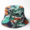 Detailed view of navy tropical leaf print bucket hat with vibrant orange and green foliage - M (56-58cm) / Style F (Dark Blue with Tropical Leaves)