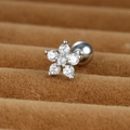 Macro shot of silver flower piercing stud with clear zircon stones on brown velvet - Silver 0.8mm