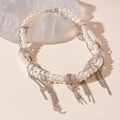 Detailed view of layered faux pearl necklace with star and moon tassel charms - Moon Star Tassel Pearl Necklace