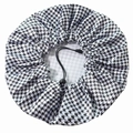 Detail of adjustable drawstring and houndstooth pattern on the waterproof shower cap - Houndstooth