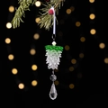 Macro shot of clear and green crystal pine cone ornament hanging on a Christmas tree branch - Green