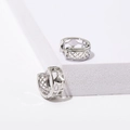 Minimalist silver lattice hollow hoop earrings with pave accents on a white display stand - Hollow Geometric / White Gold