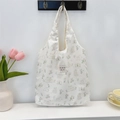 Detail of cute rabbit print and woven brand label on creamy canvas tote bag - Rabbit Paradise