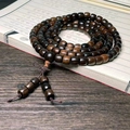 Dark brown 108-bead agarwood Buddhist bracelet with Chinese knot on vintage book - Straight Cut 8x9mmx108 Straight Grain