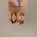 Detailopname van de vintage hars oorbellen met 18k goudlaag op een kraftpapier kaart - Koffie (18K Verguld)
