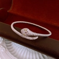 Macro shot of silver snake bracelet with white zircons and yellow gemstone eyes - Silver Pave Rhinestone Snake Open Bangle (4#)