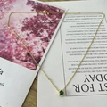 Detail of vintage gold necklace with round green zircon pendant and micro-pave crystals - May Green (Emerald Color)