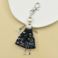 Detail of handmade doll keychain with leopard sequins and miniature bicycle charm - 16-Purple Leopard Print Doll