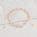 Close-up of pink quartz stone bracelet with adjustable braided rope and gold beads - Rose Quartz