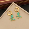 Golden hoop earrings with green butterfly pendants and beaded edges on a beige box - Stainless Steel / 3# Earrings