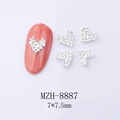 Macro view of silver heart nail charms with rhinestones measuring 7x7.5mm on lilac background - Silver Dense Crushed Diamond Heart (8887)