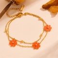 Detail of double-layer gold chain bracelet featuring three orange enamel flower pendants - Red Shell Bracelet (L503)