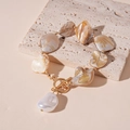 Detail of shell beaded necklace with gold chain, OT clasp and teardrop pearl pendant - Golden Irregular Shell Bracelet