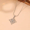 Detail shot of silver Celtic knot pendant with centered gray gemstone and snake chain - Steel Style 7 (C414)