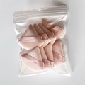 Bulk pack of pink triangle powder puffs with ribbon handles in a transparent sealed bag - 8pcs in Bag / Nude