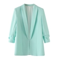 Detail van de muntgroene blazer met geplooide mouwen en gladde stofstructuur - Lichtblauw