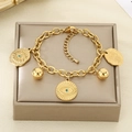 Detail of gold evil eye and hamsa hand charms on a chunky stainless steel bracelet - Evil Eye & Hamsa Hand Charms Style (KB204085-SXSJ)