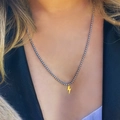 Close-up of gold lightning bolt pendant on silver box chain necklace worn by a model - Lightning Bolt Pendant Necklace / Silver Necklace Gold Pendant