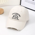 Detail of bunny embroidery and distressed holes on this cream beige baseball cap - White