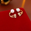 Vue macro de boucles d'oreilles perles et zircons sur une boîte en velours rouge - Or (Tige de boucle d'oreille en argent sterling 925)
