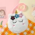 Detail of plush unicorn bag with golden horn and colorful sequin flower embellishments - White