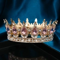 Detailed close-up of luxurious gold crown with pink teardrop gems and sparkling rhinestones - Gold / Pink