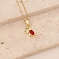 Close-up of golden bear pendant with red zircon inlay on textured stone background - Ruby Heart Bear (6#)