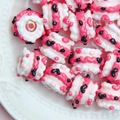 Close-up of pink and white resin dessert-style beads on a white decorative plate - Transparent Bead + Pink + Watermelon Red Cream + Black Spade Heart