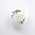White party balloon with green eucalyptus leaf wreath and golden interlocking hearts - Heart Print Balloon