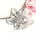Detailed macro view of holographic gradient flower hair claw clip with transparent texture - Iridescent Grey