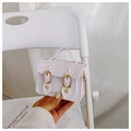 Detailed close-up of a white mini jelly handbag with golden metal chain and buckle - White