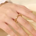 Macro shot of 2mm brushed gold titanium steel thin ring on woman's finger - US 10 / 2mm / Gold