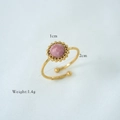 Macro detail of a 1cm pink gemstone ring with golden adjustable band and weight specifications - Rhodonite