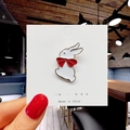 Detailed view of a cute white rabbit enamel pin with a red bow on a display card - 69*White Rabbit with Red Bowtie