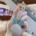 Detail of silver and blue rhinestone rabbit head keychain with a star-shaped metal clasp - Blue