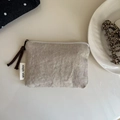 Close-up of oatmeal canvas mini pouch with white zipper and simple wish label - Solid Beige