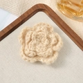 Close-up of a 7cm beige crochet flower accessory on a rustic wooden and fabric background - 7cm / Mohair Beige