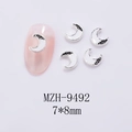 Macro view of silver crescent moon nail charms with white enamel and black glitter - Moon Silver White Style (9492)