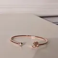 Macro detail of rose gold Om symbol and sparkling crystal on the open metal bracelet - Om Symbol (1#) / Rose Gold