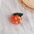 Chic orange-shaped hair claw clip made of marble-textured acetate on white linen - Orange