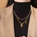 Collana barocca a doppio strato con pietra occhio di tigre e ciondolo a croce oro - Collana a Doppio Strato in Occhio di Tigre Ovale con Ciondolo a Croce Dorata