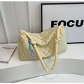 Detail of beige quilted cloud tote bag with diamond stitching and woven rope charm - Light Yellow
