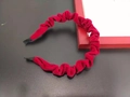 Close-up detail of the red velvet pleated texture on the thin elegant headband - Red
